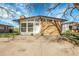 Charming brick home featuring expansive windows and a well-maintained front yard and inviting front door at 5373 S Prescott St, Littleton, CO 80120