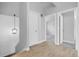 Light and bright hallway with hardwood floors and modern lighting at 5373 S Prescott St, Littleton, CO 80120