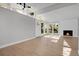 Light-filled living room showcasing a fireplace, high ceilings with clerestory windows, and light hardwood floors at 5373 S Prescott St, Littleton, CO 80120