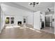 Open concept living room boasts hardwood floors, a fireplace, and seamlessly connects to a stainless steel kitchen at 5373 S Prescott St, Littleton, CO 80120