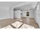 Open-concept living room with bright hardwood floors and an open doorway to the rest of the house at 5373 S Prescott St, Littleton, CO 80120
