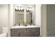 Double vanity bathroom with updated fixtures and a large mirror at 22032 E 38Th Pl, Aurora, CO 80019