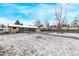 Expansive backyard with a sunroom featuring lots of natural light and a shed for extra storage at 779 Alkire St, Lakewood, CO 80401