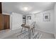 Basement office area with neutral carpet, desk and chair, and built-in shelving provides a functional workspace at 779 Alkire St, Lakewood, CO 80401