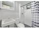 Compact bathroom with white tile, updated fixtures, and a shower/tub combination for a clean, modern feel at 779 Alkire St, Lakewood, CO 80401