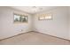 Simple bedroom with carpeted floors and natural light streaming through the windows at 779 Alkire St, Lakewood, CO 80401