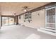 Bright sunroom features brick walls, large windows, and ceiling fans, creating an inviting space for relaxation at 779 Alkire St, Lakewood, CO 80401