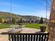 Spacious backyard featuring a picnic table, a swing, and scenic views of the surrounding neighborhood and landscape at 15116 Lyons Ridge Dr, Morrison, CO 80465