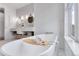 Bright bathroom with a soaking tub and double sink vanity at 15116 Lyons Ridge Dr, Morrison, CO 80465