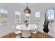 Bright dining room with large windows offering natural light, featuring modern table and seating at 15116 Lyons Ridge Dr, Morrison, CO 80465