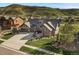 Beautiful two-story house showcasing a large driveway, well-maintained lawn, and attractive landscaping at 15116 Lyons Ridge Dr, Morrison, CO 80465