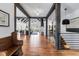 Open foyer with wood flooring, exposed beams, staircase, and views to living areas at 15116 Lyons Ridge Dr, Morrison, CO 80465