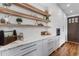 Well-appointed kitchen with marble countertops, open shelving, and modern cabinets at 15116 Lyons Ridge Dr, Morrison, CO 80465