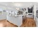 Open kitchen featuring a large center island, barstool seating, and seamless flow to the living area at 15116 Lyons Ridge Dr, Morrison, CO 80465