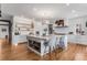 Modern kitchen featuring a center island, open shelving, and updated appliances at 15116 Lyons Ridge Dr, Morrison, CO 80465