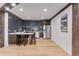 A stylish kitchenette with granite countertops, a wine rack, stainless steel appliances, and dark wood trim at 15116 Lyons Ridge Dr, Morrison, CO 80465