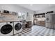 Well-organized laundry room featuring modern appliances and ample storage at 15116 Lyons Ridge Dr, Morrison, CO 80465