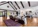 Open-concept living room featuring a fireplace, wood floors, and a seamless flow to the kitchen at 15116 Lyons Ridge Dr, Morrison, CO 80465