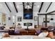 Stunning living room with fireplace, beamed ceilings, and luxurious leather furniture at 15116 Lyons Ridge Dr, Morrison, CO 80465
