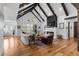 Inviting living room with vaulted ceilings, fireplace, and expansive windows offering scenic views at 15116 Lyons Ridge Dr, Morrison, CO 80465
