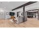 Open-concept living room with hardwood floors, comfortable seating, and views of the kitchen at 15116 Lyons Ridge Dr, Morrison, CO 80465