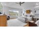 Spacious main bedroom with scenic views, ceiling fan, light hardwood floors, and neutral decor at 15116 Lyons Ridge Dr, Morrison, CO 80465