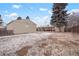 The backyard offers a detached garage and covered patio with seating, partially covered in snow at 3298 S Eudora St, Denver, CO 80222