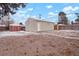 The backyard features a storage shed and detached garage with partial snow coverage on the ground at 3298 S Eudora St, Denver, CO 80222