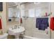 Bright bathroom featuring a modern vanity, glass-enclosed shower, and stylish fixtures at 3298 S Eudora St, Denver, CO 80222