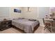 This bedroom features neutral walls, carpet floors, and a gray bed with a desk and dark-wood nightstand at 3298 S Eudora St, Denver, CO 80222