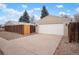The detached garage offers ample parking space with gravel landscaping, enhancing curb appeal at 3298 S Eudora St, Denver, CO 80222