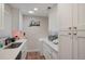 Clean kitchenette features sleek white cabinets, modern appliances, and a minimalist design at 3298 S Eudora St, Denver, CO 80222