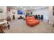 The living room is spacious with carpet floors, a TV, and a large orange beanbag chair at 3298 S Eudora St, Denver, CO 80222