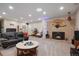 Cozy living room with a stone fireplace, plush seating, and ample lighting for relaxation at 3298 S Eudora St, Denver, CO 80222