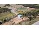 Aerial shot of the property, showcasing mature trees, the athletic fields, and proximity to local roads at 10550 Highway 73, Conifer, CO 80433