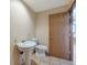 Small bathroom featuring a pedestal sink, toilet, and tiled floors at 10550 Highway 73, Conifer, CO 80433