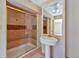 Bathroom featuring a tiled shower with glass door and pedestal sink at 10550 Highway 73, Conifer, CO 80433