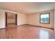 Bedroom with hardwood floors and views of greenery from the window at 10550 Highway 73, Conifer, CO 80433
