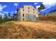 View of the rear of the home featuring a basement and outdoor basketball court at 10550 Highway 73, Conifer, CO 80433