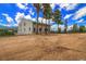 Charming home with a large yard surrounded by tall pine trees under a blue sky at 10550 Highway 73, Conifer, CO 80433