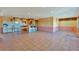 Open concept kitchen and living area with tile floors and bar seating at 10550 Highway 73, Conifer, CO 80433