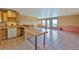 Spacious kitchen/living area with wood cabinets, tile counters, bar, and seating at 10550 Highway 73, Conifer, CO 80433
