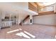 Open concept living room with tile flooring, wood staircase, and natural light at 10550 Highway 73, Conifer, CO 80433
