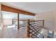 Lofted living area with tile floors and a unique wooden railing at 10550 Highway 73, Conifer, CO 80433