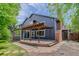 Exterior of the home showcasing a wooden pergola, brick chimney, and spacious backyard with stone pathway at 7831 W 109Th Ave, Westminster, CO 80021