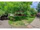 Lush backyard featuring manicured landscaping, a charming shed, and a stone pathway leading through the lawn at 7831 W 109Th Ave, Westminster, CO 80021