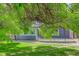 Spacious backyard with mature trees, lush lawn, stone pathway, and the home's exterior with a wooden deck at 7831 W 109Th Ave, Westminster, CO 80021