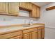 Basement bar area with cabinetry, tile countertop, and open shelving at 7831 W 109Th Ave, Westminster, CO 80021