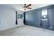 Cozy bedroom features two windows with blue curtains and a ceiling fan at 7831 W 109Th Ave, Westminster, CO 80021