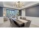Elegant dining room with a modern chandelier and view into the living room, perfect for entertaining at 7831 W 109Th Ave, Westminster, CO 80021